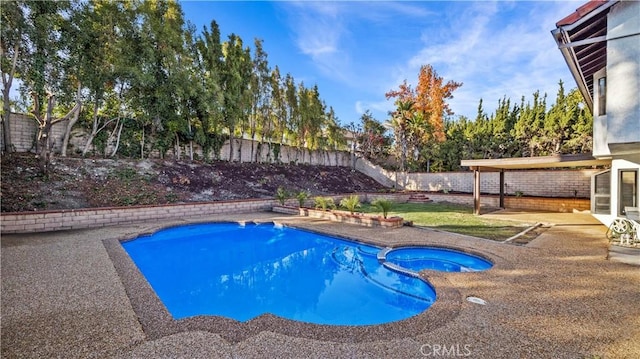 view of swimming pool with a patio area and an in ground hot tub