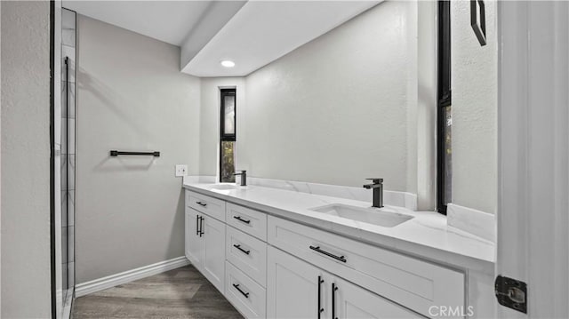 bathroom with hardwood / wood-style floors and vanity