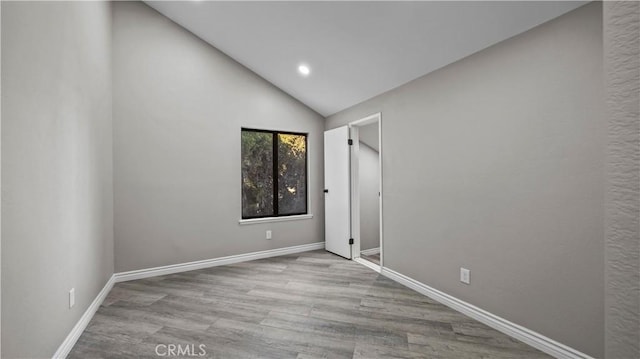 interior space featuring light wood-type flooring and lofted ceiling