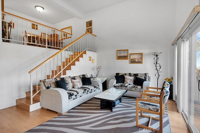 living room featuring light hardwood / wood-style flooring and beamed ceiling