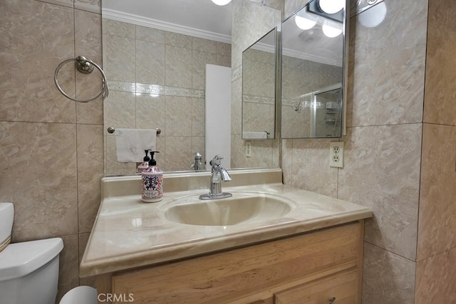 bathroom featuring vanity, toilet, tile walls, and crown molding