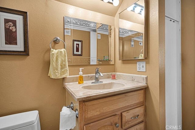 bathroom with vanity and toilet