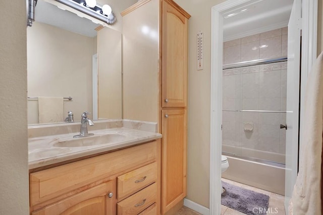 full bathroom with tile patterned flooring, vanity, tiled shower / bath combo, and toilet