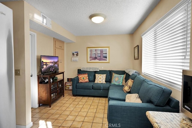 living room with light tile patterned floors and a textured ceiling