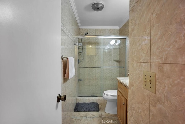 bathroom with vanity, toilet, ornamental molding, tile walls, and walk in shower