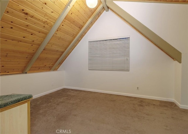 additional living space featuring carpet flooring, wooden ceiling, and lofted ceiling with beams