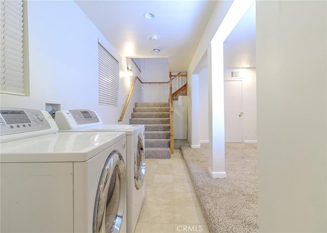 washroom featuring washing machine and dryer and light tile patterned floors