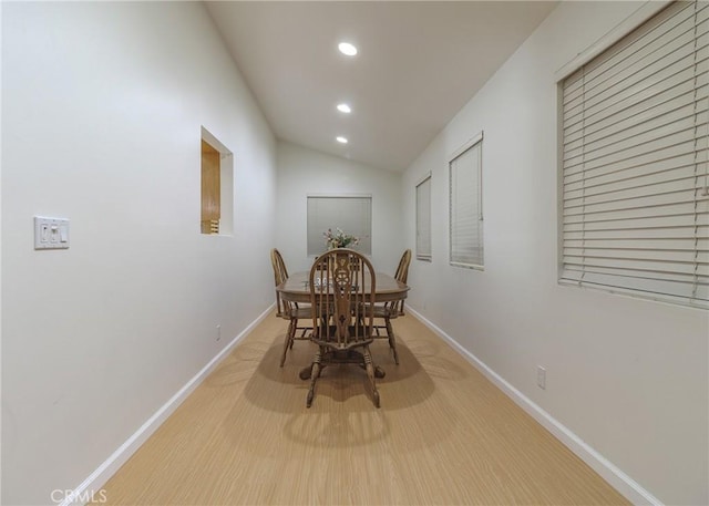 dining area featuring light hardwood / wood-style floors and lofted ceiling