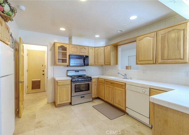 kitchen featuring sink, white appliances, backsplash, and tile countertops