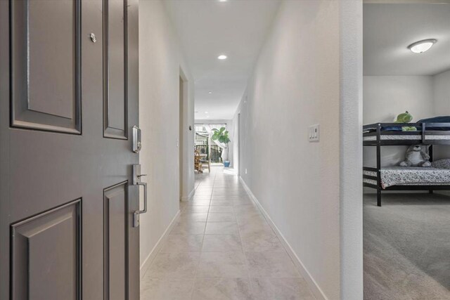 hallway with light tile patterned floors