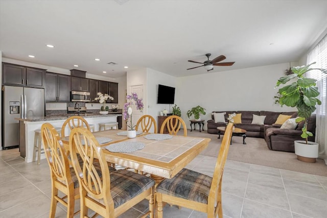 dining space featuring ceiling fan and light tile patterned floors