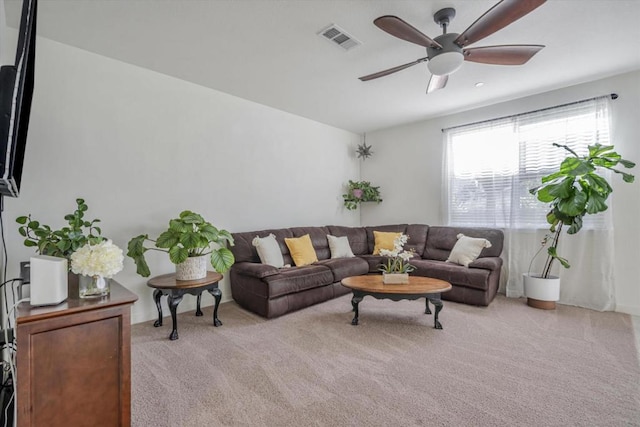 carpeted living room featuring ceiling fan