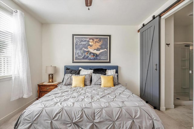 bedroom with a barn door and ceiling fan