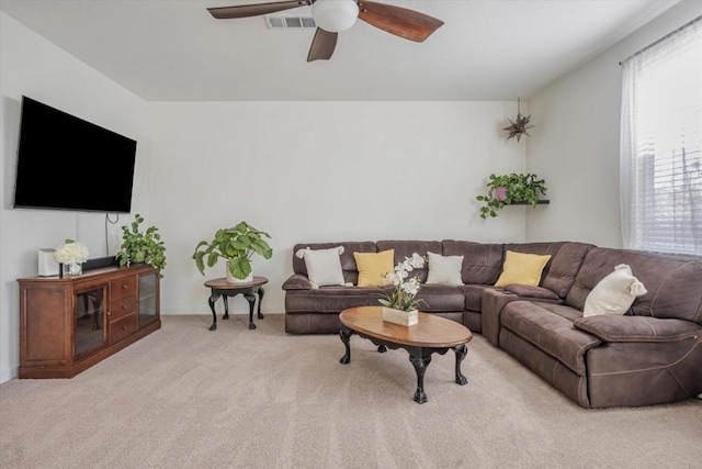 living room featuring light carpet and ceiling fan