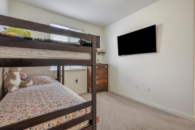 bedroom with multiple windows and light colored carpet