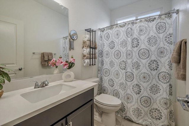 bathroom featuring vanity, toilet, and curtained shower