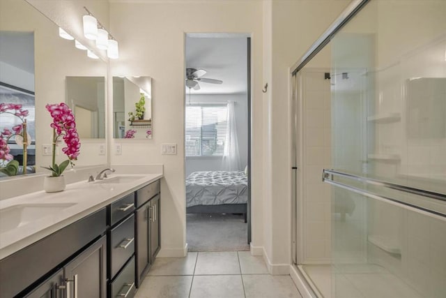 bathroom with tile patterned flooring, vanity, ceiling fan, and a shower with shower door