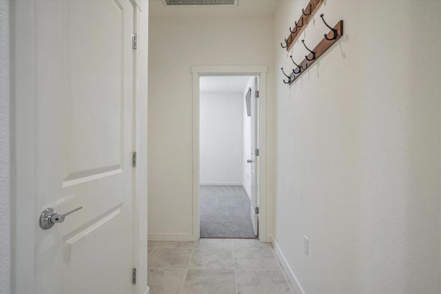 hall featuring light colored carpet