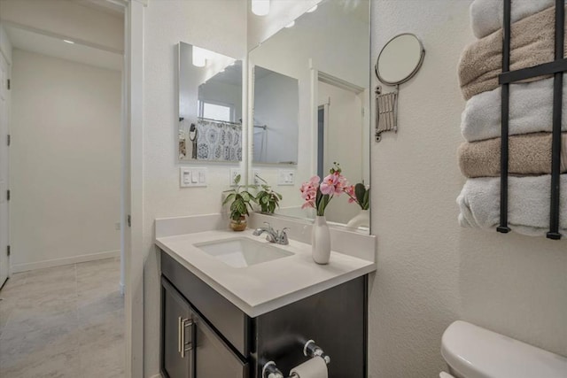 bathroom featuring vanity and toilet