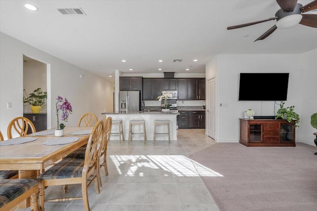 dining room featuring ceiling fan and light tile patterned flooring