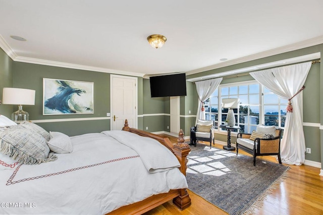 bedroom with wood-type flooring, ornamental molding, and a closet