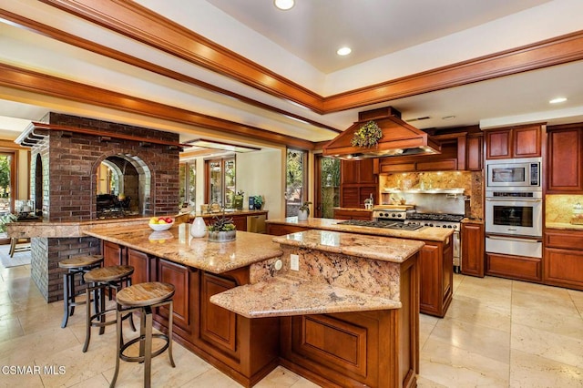 kitchen with premium range hood, tasteful backsplash, a kitchen island, and stainless steel appliances