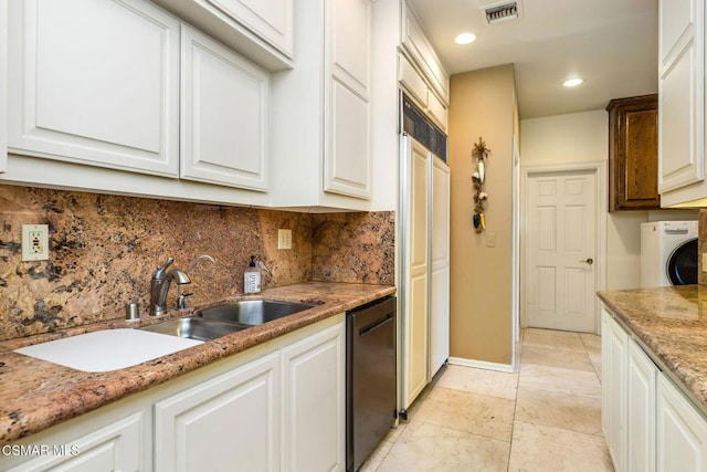 kitchen with sink, black dishwasher, washer / dryer, decorative backsplash, and white cabinets