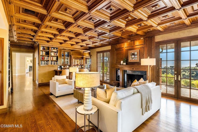 living room with beam ceiling, french doors, coffered ceiling, crown molding, and light wood-type flooring