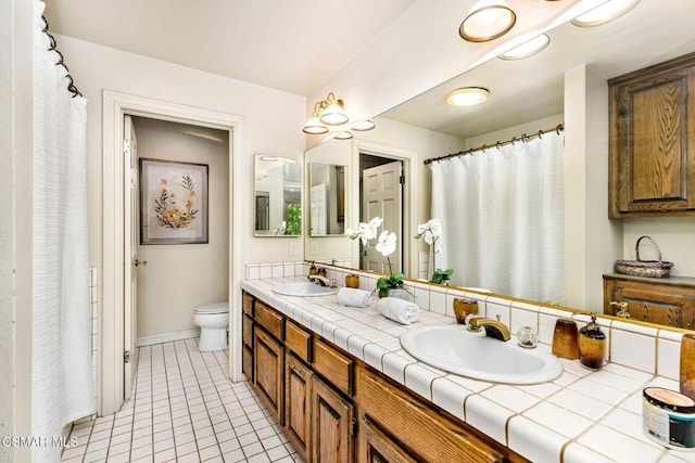 bathroom featuring tile patterned floors, vanity, and toilet