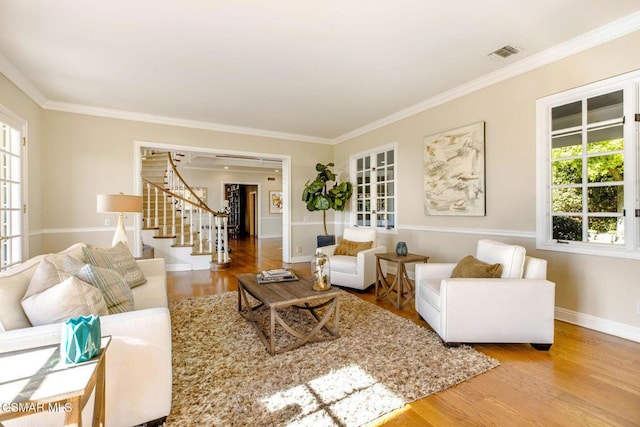 living room featuring hardwood / wood-style floors and crown molding