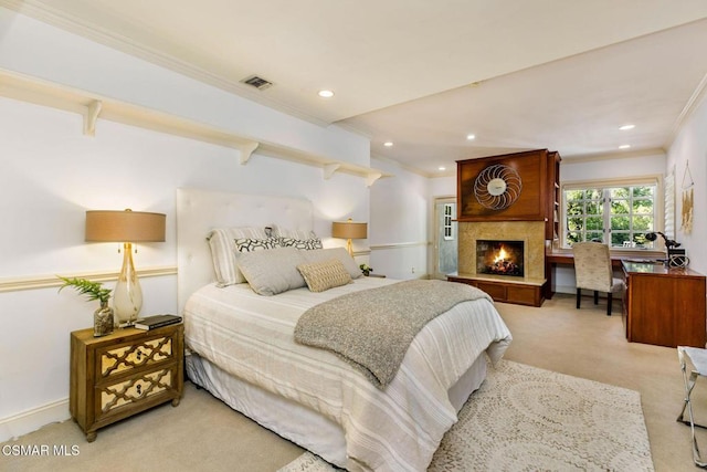 carpeted bedroom with crown molding and a large fireplace