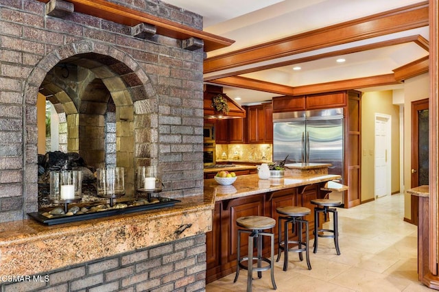 bar featuring built in appliances, tasteful backsplash, light stone counters, and ornamental molding