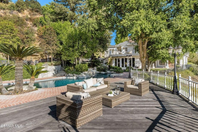 wooden deck featuring a fenced in pool