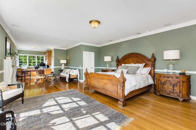 bedroom with hardwood / wood-style floors and ornamental molding