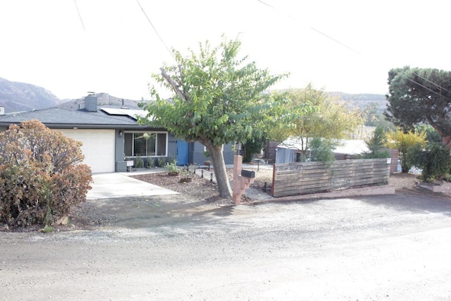 view of front facade with a garage and solar panels