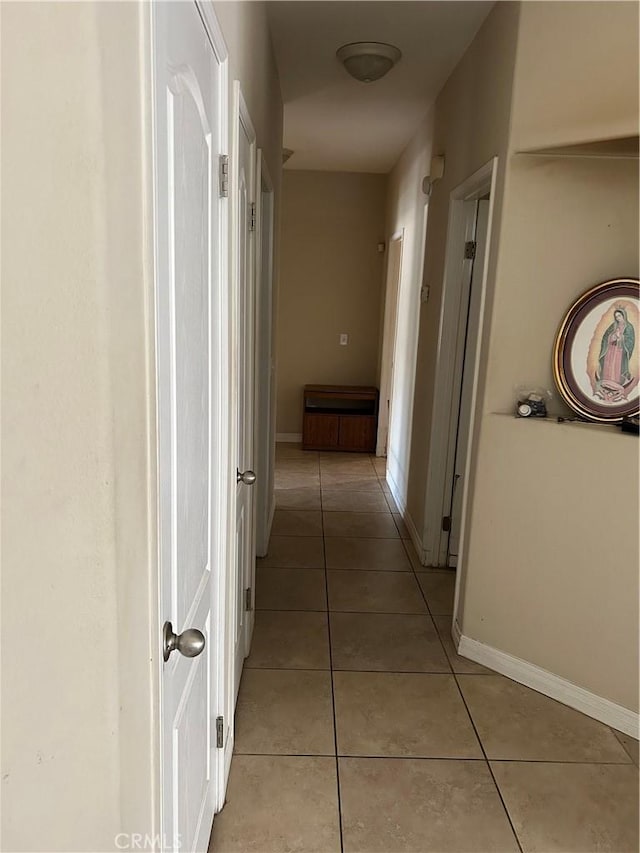 hallway with light tile patterned floors