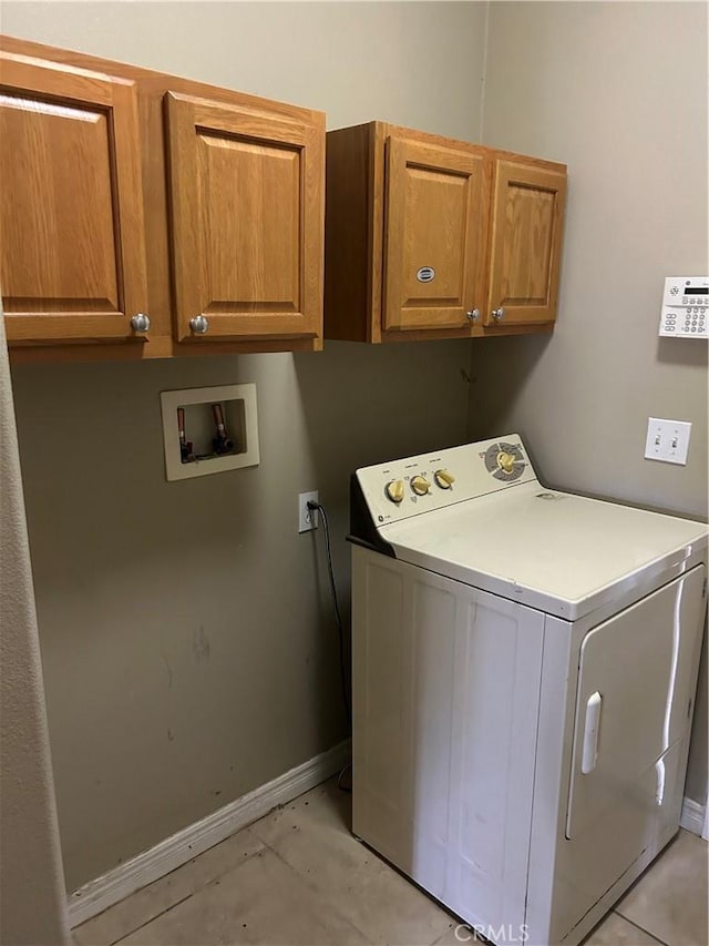 clothes washing area with cabinets and washer / clothes dryer