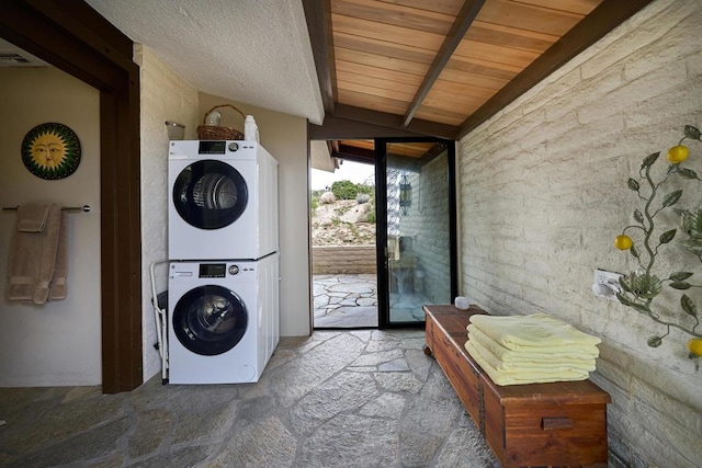 washroom with carpet, wood ceiling, and stacked washer / dryer