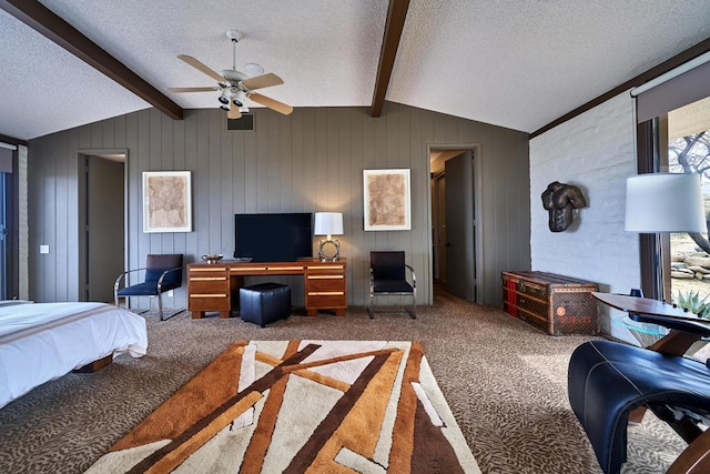 bedroom with ceiling fan, lofted ceiling with beams, carpet floors, a textured ceiling, and wooden walls