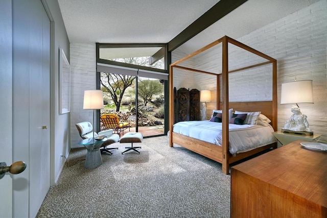 bedroom featuring vaulted ceiling with beams, carpet floors, a textured ceiling, and access to exterior