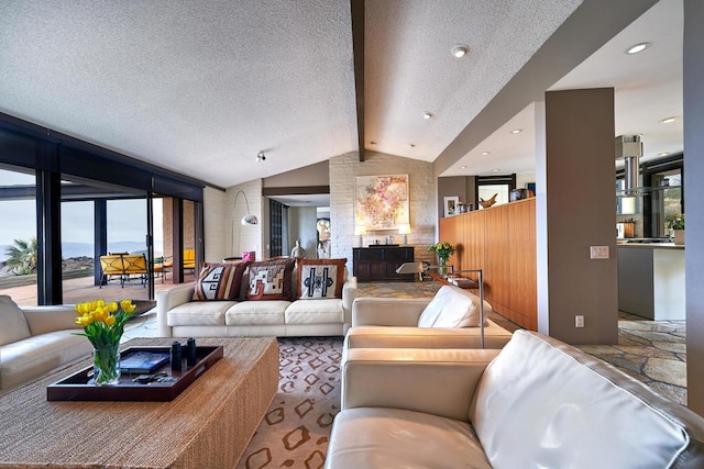 living room featuring lofted ceiling with beams, a healthy amount of sunlight, and a textured ceiling