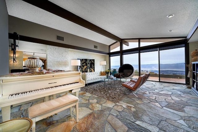 living room with vaulted ceiling with beams, a textured ceiling, and a water and mountain view