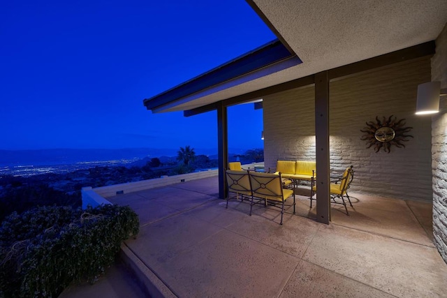 patio terrace at dusk featuring outdoor lounge area