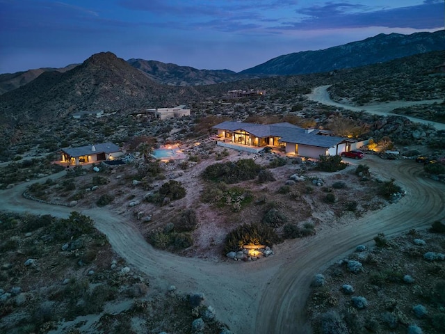 aerial view at dusk featuring a mountain view