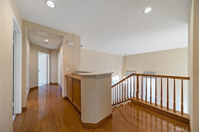 hallway with hardwood / wood-style flooring