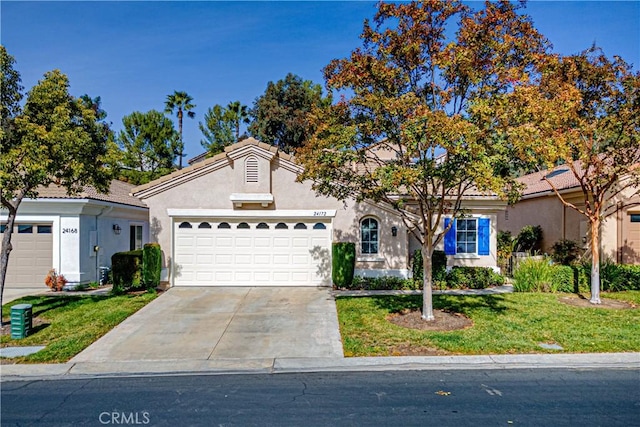 view of front of home featuring a front yard and a garage