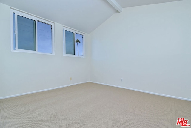 carpeted spare room with vaulted ceiling with beams