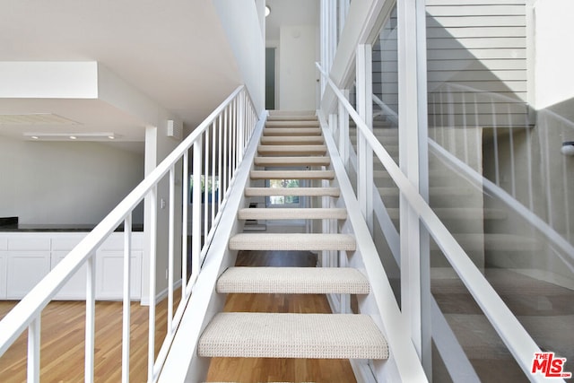 stairway featuring hardwood / wood-style flooring