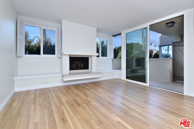 unfurnished living room with light wood-type flooring