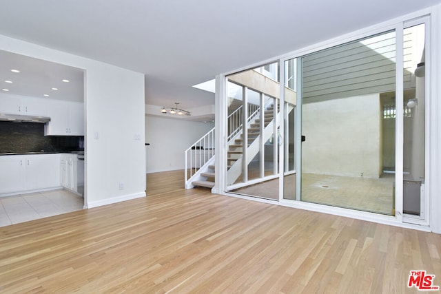 unfurnished living room featuring light hardwood / wood-style flooring